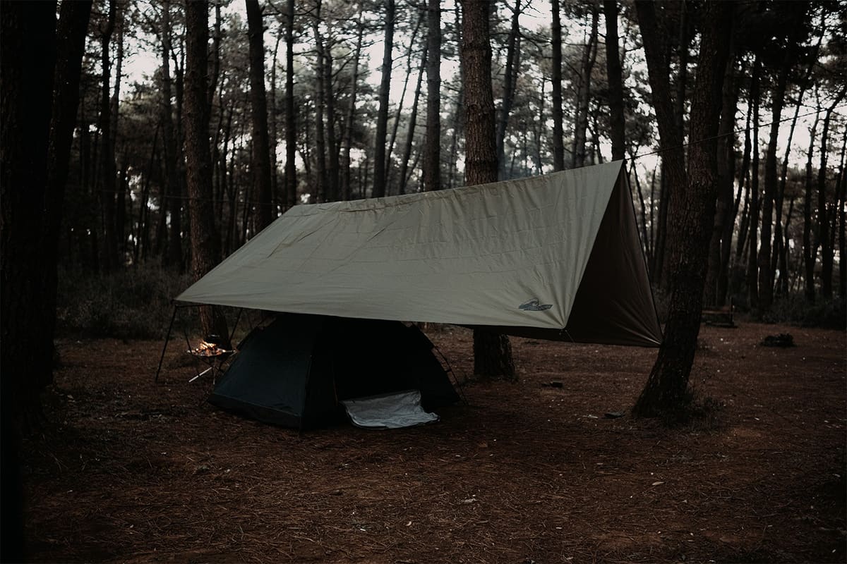 Ragnar tarp on a line between two pines, pitched over a Midgard tent