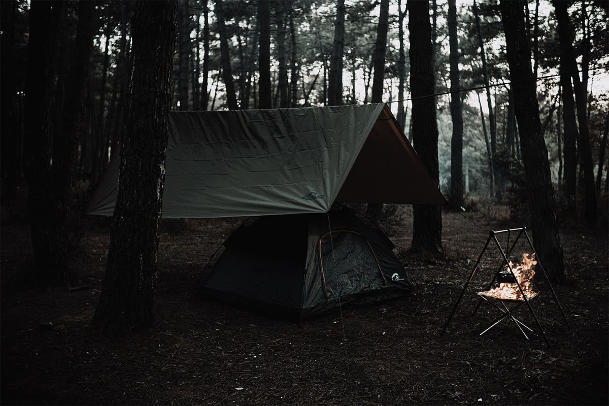 Ragnar tarp pitched over a Midgard tent, fire bowl on the right